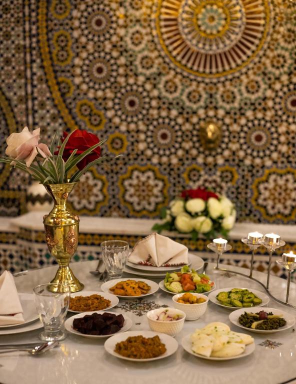 Table marocaine dressée devant une fontaine en zelliges